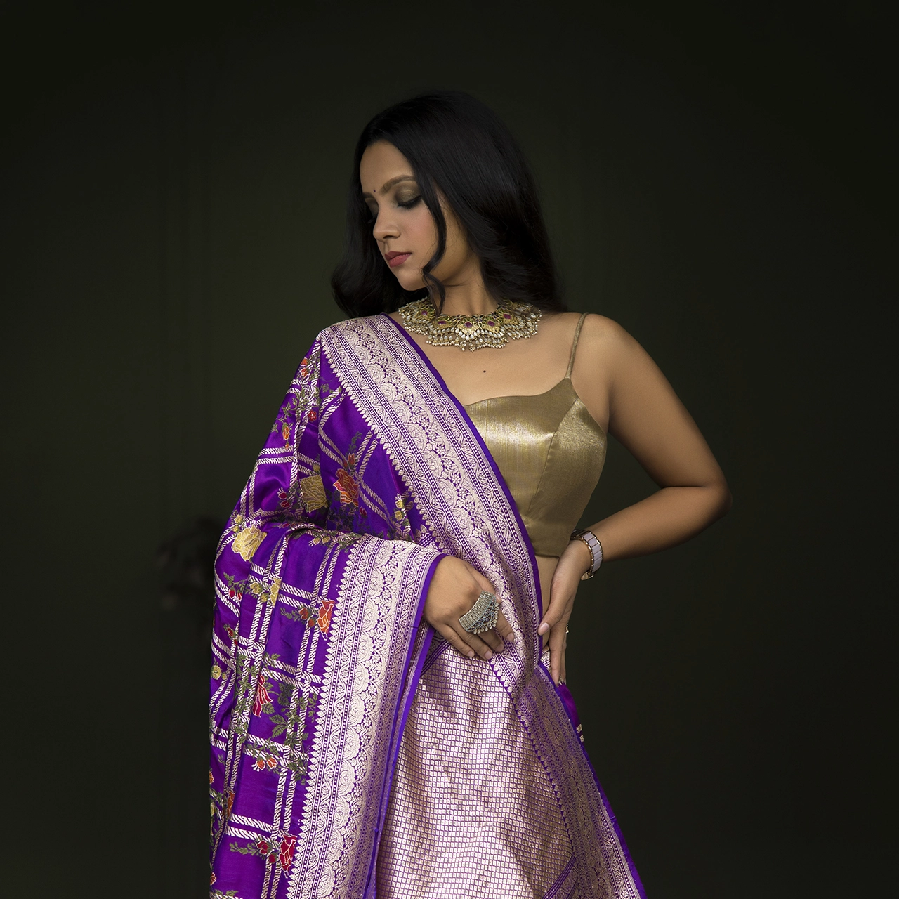 Photography Portfolio Royal purple Banarasi silk saree with gold zari work and traditional jewelry editorial fashion photography on dark background - Content Crest Media traditional fashion photography portfolio Ahmedabad Gujarat