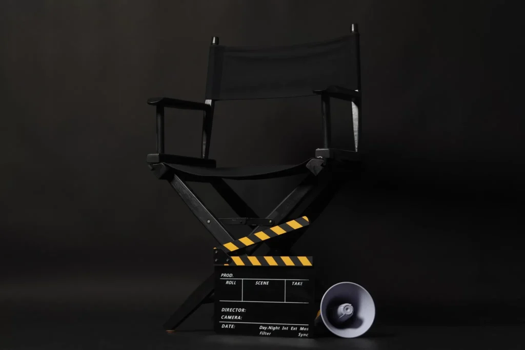The Power of Corporate Films: Telling Your Business Story with Heart Black director's chair with professional film clapperboard featuring yellow and black stripes representing corporate film production and business storytelling by Content Crest Media Ahmedabad Gujarat